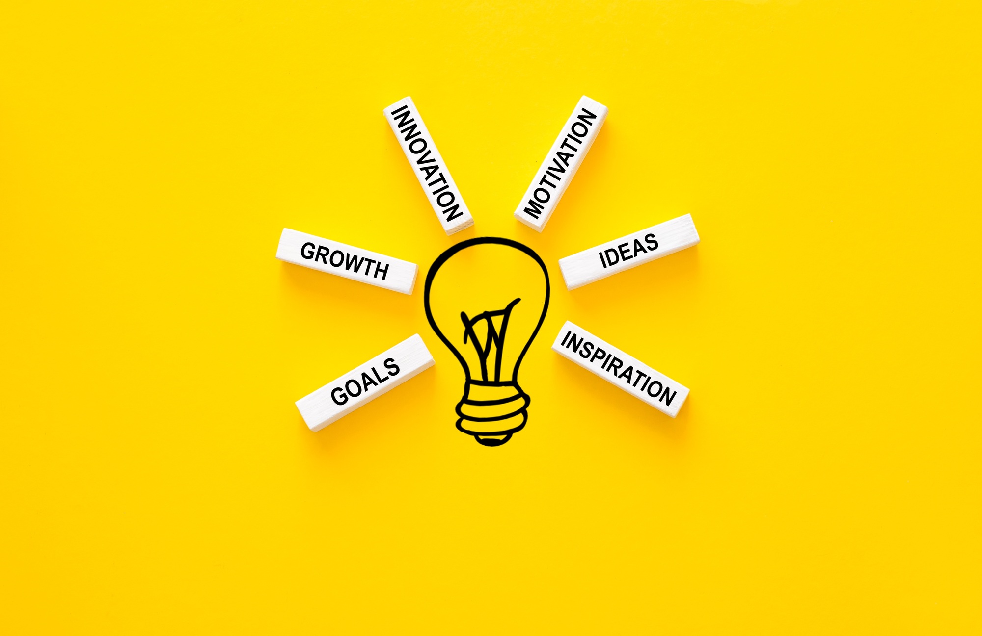 Lightbulb and wooden blocks with innovation basic links. Business ideas inspiration and innovation.