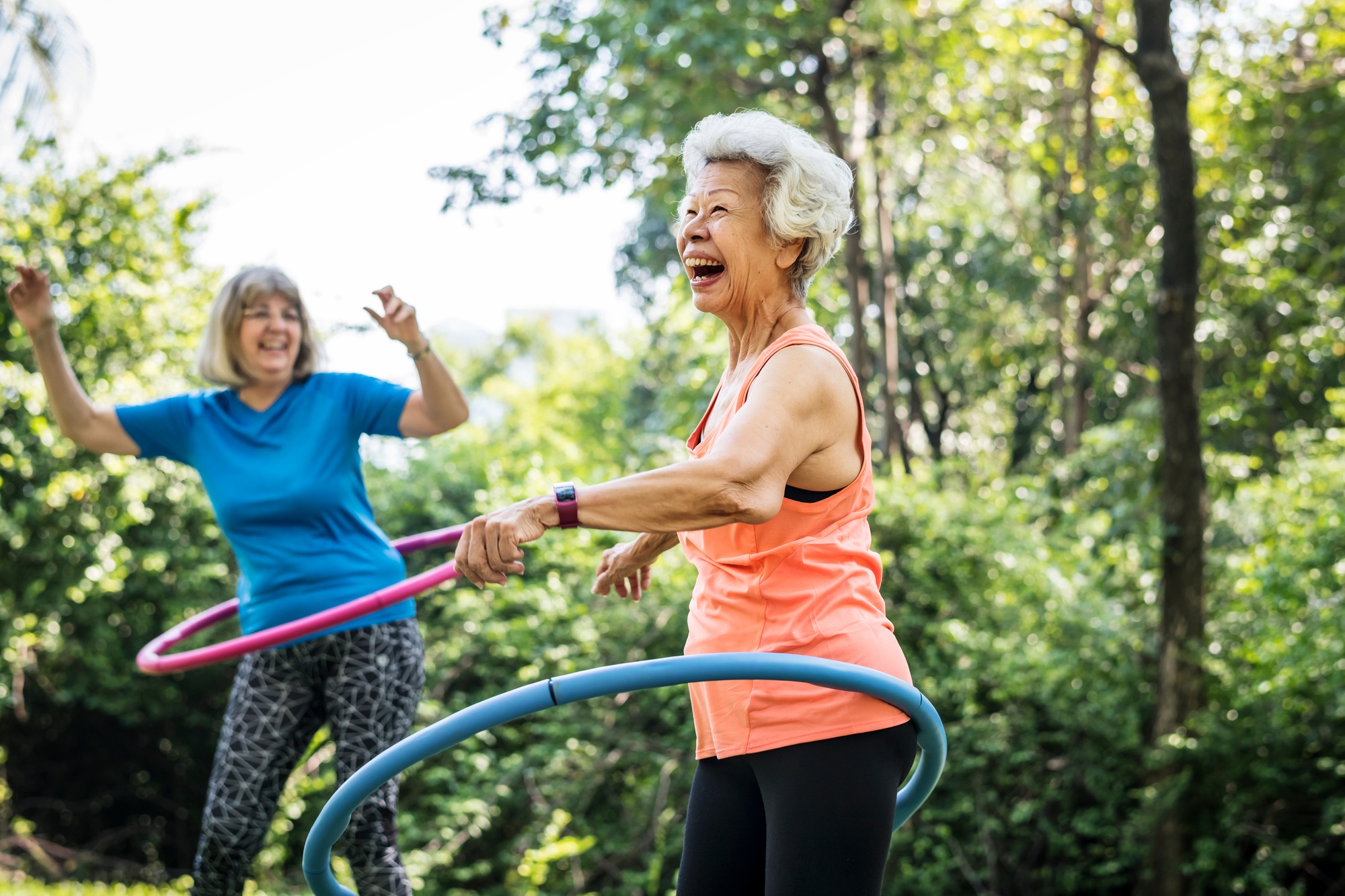Senior woman exercising with a hula hoop