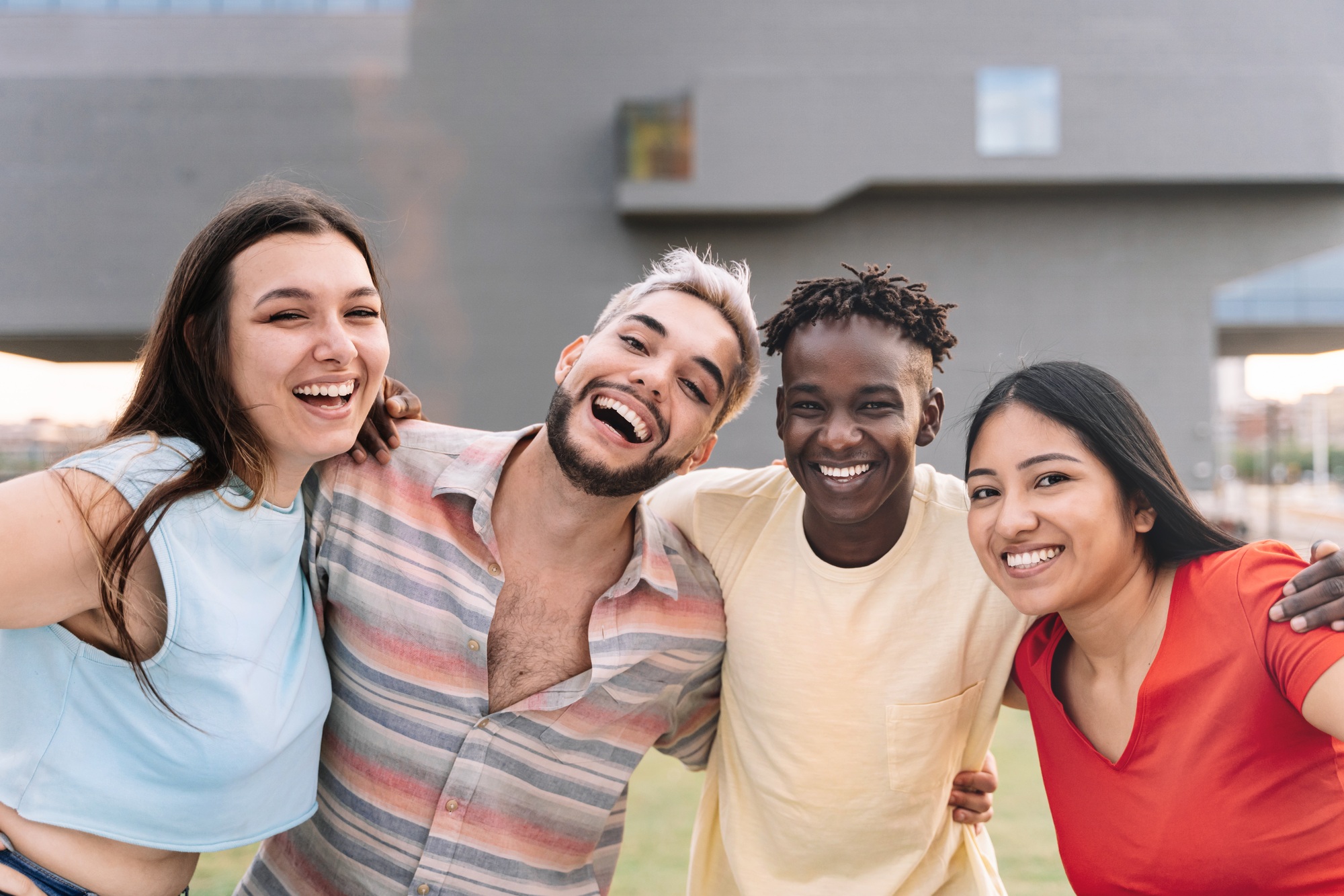 young diverse multi-ethnic friends enjoying good moments and having fun together outdoors